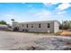 Wide angled view of a gray house exterior with a door, an AC unit and several windows at 147 Woodstork Way, Frostproof, FL 33843