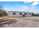New construction home with gray siding, black shutters, and small front porch at 147 Woodstork Way, Frostproof, FL 33843