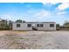 New construction home with gray siding, black shutters, and small front porch at 147 Woodstork Way, Frostproof, FL 33843