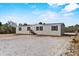 New construction home with gray siding, black shutters, and small front porch at 147 Woodstork Way, Frostproof, FL 33843