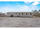 Wide view of the exterior of the gray home with several windows and a back door at 147 Woodstork Way, Frostproof, FL 33843
