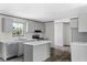 Kitchen with gray cabinets, island with marble top, and stainless appliances at 147 Woodstork Way, Frostproof, FL 33843