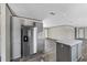 Modern kitchen boasts stainless steel appliances, an island, and stylish gray cabinets at 147 Woodstork Way, Frostproof, FL 33843