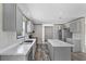 Kitchen with gray cabinets and stainless steel appliances and a marble island at 147 Woodstork Way, Frostproof, FL 33843