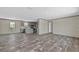 Open concept living room and kitchen with modern gray floors at 147 Woodstork Way, Frostproof, FL 33843