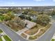 Aerial view of a neighborhood, featuring mature trees, and water views in the distance at 1602 Oak Hollow Rd, Clermont, FL 34711