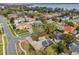 Aerial view showcasing a charming neighborhood with homes, green spaces, and a glimpse of the lake at 1602 Oak Hollow Rd, Clermont, FL 34711