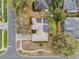 Birds eye view of a single-Gathering house featuring solar panels, screened in patio and mature landscaping at 1602 Oak Hollow Rd, Clermont, FL 34711