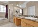 Bathroom featuring a double sink vanity, large mirror, walk-in shower, and a soaking tub at 1602 Oak Hollow Rd, Clermont, FL 34711