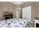 Cozy bedroom with neutral walls, carpet floors, and a large television at 1602 Oak Hollow Rd, Clermont, FL 34711
