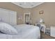 Bright bedroom featuring a well-lit vanity and mirrored closet doors at 1602 Oak Hollow Rd, Clermont, FL 34711
