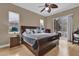 Comfortable bedroom featuring a ceiling fan, ample natural light, and access to the screened-in patio at 1602 Oak Hollow Rd, Clermont, FL 34711