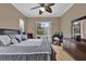 Comfortable bedroom featuring a ceiling fan, ample natural light, and access to the screened-in patio at 1602 Oak Hollow Rd, Clermont, FL 34711