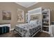 A cozy bedroom with a Murphy bed, built-in bookshelves, and bright lighting at 1602 Oak Hollow Rd, Clermont, FL 34711