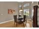Dining area with hardwood floors, a glass table, and arched windows at 1602 Oak Hollow Rd, Clermont, FL 34711