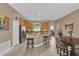 Open kitchen with granite countertops, stainless steel appliances, tile floors, and bar seating at 1602 Oak Hollow Rd, Clermont, FL 34711