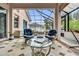 Beautiful sunroom with tiled floors, comfortable seating, and a glass ceiling for natural light at 1602 Oak Hollow Rd, Clermont, FL 34711