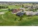 An aerial view showcases the lush golf course community of Stonecrest with manicured lawns and mature trees at 17126 Se 117Th Cir, Summerfield, FL 34491