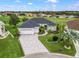 Beautiful home with well manicured landscaping, a paver driveway and three-car garage, located on a golf course at 17126 Se 117Th Cir, Summerfield, FL 34491