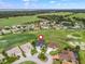 Aerial view of a single-Gathering home in a golf community surrounded by lush landscaping and beautiful greenery at 17126 Se 117Th Cir, Summerfield, FL 34491
