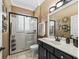 Bright bathroom with a glass-enclosed shower, white tile, and neutral countertops at 17126 Se 117Th Cir, Summerfield, FL 34491