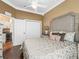 Inviting bedroom with a large bed, closet, and doorway into a beverage center at 17126 Se 117Th Cir, Summerfield, FL 34491