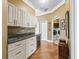 Hallway with a drink station and doorway into the laundry room with appliances at 17126 Se 117Th Cir, Summerfield, FL 34491