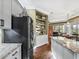 Bright kitchen features a center island, granite counters, stainless appliances, and display shelving at 17126 Se 117Th Cir, Summerfield, FL 34491