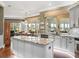 Bright kitchen features granite counters, stainless appliances, island, and view to backyard at 17126 Se 117Th Cir, Summerfield, FL 34491