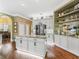 Bright kitchen features a center island, granite counters, stainless appliances, and display shelving at 17126 Se 117Th Cir, Summerfield, FL 34491