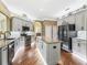 Bright kitchen features a center island, granite counters, stainless appliances, and tile backsplash at 17126 Se 117Th Cir, Summerfield, FL 34491