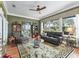 Living room features large windows, neutral paint, area rug, and a ceiling fan at 17126 Se 117Th Cir, Summerfield, FL 34491