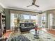 Living room features large windows, neutral paint, area rug, and a ceiling fan at 17126 Se 117Th Cir, Summerfield, FL 34491
