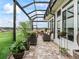 Screened patio with brick floors, seating and view of the back yard at 17126 Se 117Th Cir, Summerfield, FL 34491