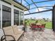 Relaxing outdoor patio with furniture, dining area and open lawn views at 17126 Se 117Th Cir, Summerfield, FL 34491