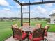 Screened patio with dining set and open views of the green lawn and community at 17126 Se 117Th Cir, Summerfield, FL 34491
