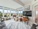 Bright sunroom with walls of windows and comfortable seating, perfect for relaxing and enjoying the view at 17126 Se 117Th Cir, Summerfield, FL 34491