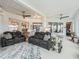 Bright sunroom boasts comfortable seating, ceiling fans, and lots of natural light at 17126 Se 117Th Cir, Summerfield, FL 34491