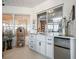 This sunroom features a convenient kitchenette with marble countertop, white cabinetry, and mini fridge at 17126 Se 117Th Cir, Summerfield, FL 34491