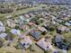 A stunning aerial view showcases a well-maintained home in a golf course community with mature landscaping and beautiful surroundings at 17694 Se 88Th Covington Cir, The Villages, FL 32162