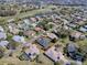 Wide aerial view of a home near a golf course and a lake in a well-established neighborhood at 17694 Se 88Th Covington Cir, The Villages, FL 32162