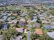Beautiful aerial shot of a residential home near a verdant golf course and sparkling lake at 17694 Se 88Th Covington Cir, The Villages, FL 32162