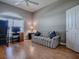 Neutral-toned bedroom featuring a comfortable sofa and bright natural light at 17694 Se 88Th Covington Cir, The Villages, FL 32162