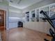 Spacious bedroom with built-in shelving, an exercise machine, and wood-look floors at 17694 Se 88Th Covington Cir, The Villages, FL 32162