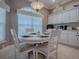 Bright breakfast nook featuring a round table, white cabinets, and backsplash at 17694 Se 88Th Covington Cir, The Villages, FL 32162