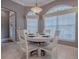 Cozy dining area with a round table, chairs, and natural light from large windows at 17694 Se 88Th Covington Cir, The Villages, FL 32162