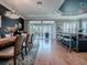 Bright dining area with bar seating, sliding glass doors, and modern finishes at 17694 Se 88Th Covington Cir, The Villages, FL 32162