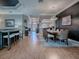 Bright dining room featuring a modern chandelier and stylish wood-look flooring at 17694 Se 88Th Covington Cir, The Villages, FL 32162