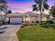 Charming single-story home featuring a well-manicured lawn and a two-car garage at 17694 Se 88Th Covington Cir, The Villages, FL 32162