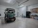 Bright two car garage with golf cart, storage, and epoxy floors at 17694 Se 88Th Covington Cir, The Villages, FL 32162